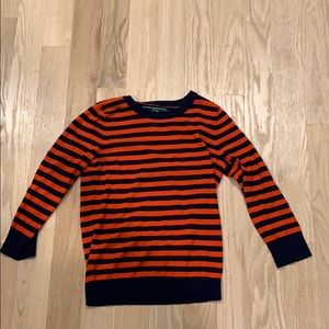 red/orange and navy blue striped sweater.